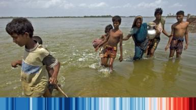 People walking through a flooded area