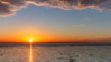 A photo of a beach sunset