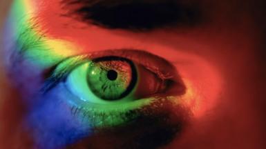 Close up of eye with spectrum of light