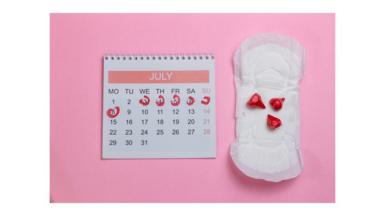 Directly Above Shot Of Sanitary Pad By Calendar Over Pink Background