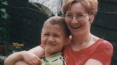 Luke as a child in the arms of his mum Liz