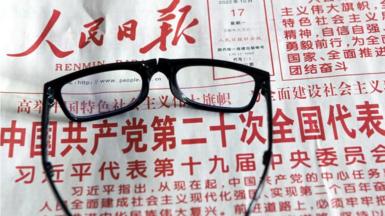 A citizen reads a newspaper to learn about the report of the 20th Communist Party of China (CPC) Congress in Shenyang, Liaoning province, China, Oct 17, 2022.