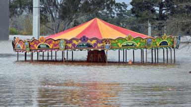 An amusement ride is seen inundated by floodwaters in Camden in South Western Sydney.