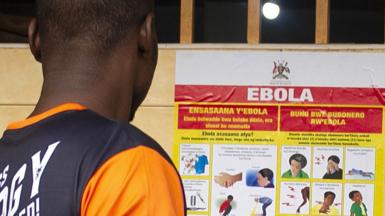 A man looking at an Ebola information poster in Kampala, Uganda - September 2022