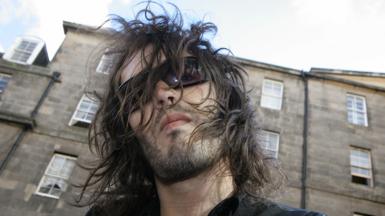 Russell Brand with hair over his face in Edinburgh 2006