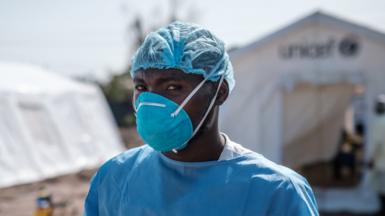 Medical worker outside a treatment centre in Mozambique, March 2019