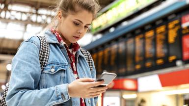 Person on phone at train station