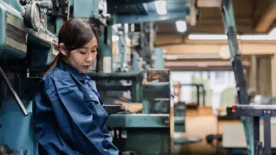 Mujer joven china cansada en una fábrica