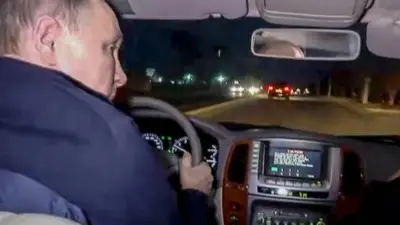 President Putin driving at night-time