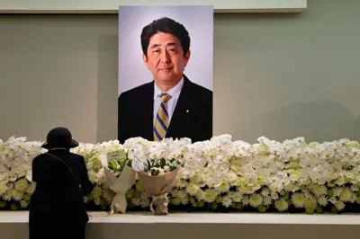 A mourner pays respects to late former Japanese Prime Minister Shinzo Abe