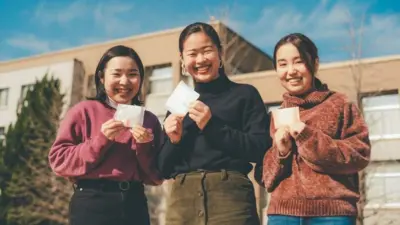 Period campaigners in Japan holding sanitary pads.
