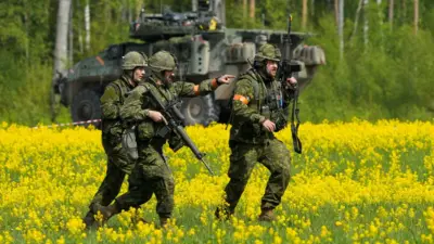 Canadian soldiers of the NATO Enhanced Forward Presence battlegroup run during a military drill