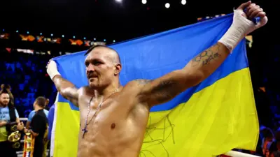 Oleksandr Usyk with Ukraine flag after beating Anthony Joshua in Saudi Arabia
