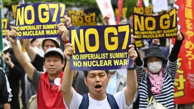 People demonstrate on May 19, 2023 in Hiroshima city, Japan, as they protest against the G7 Hiroshima Summit.