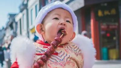 A small boy in traditional outfit for Chinese New Year in Beijing.