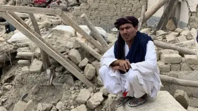 Image shows two men amid rubble
