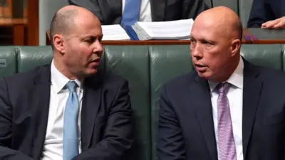 Josh Frydenberg and Petter Dutton sit in Australia's parliament