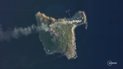 Satellite view shows smoke rising over Snake Island, Ukraine amid Russia"s attack on the country, May 8, 2022