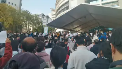 A crowd of students at Beijing's Tsinghua University protest against Covid measures
