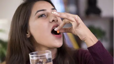 गर्भनिरोधक गोळी घेताना महिला