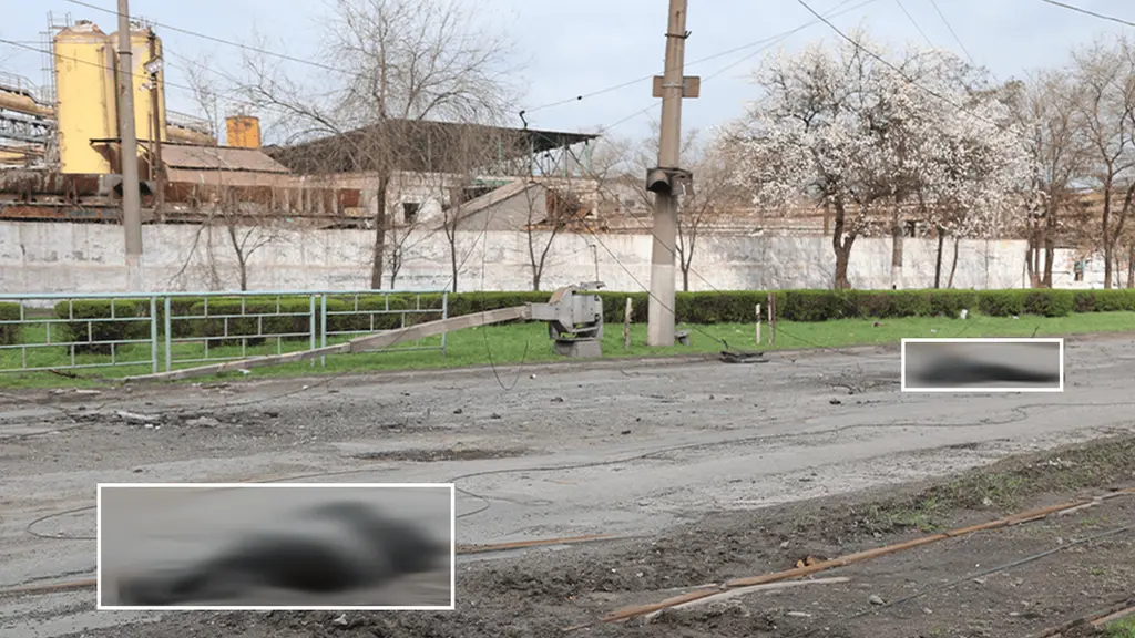 Bodies blurred on road in Mariupol