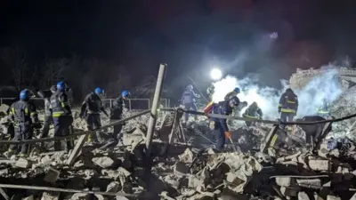 Rescuers work at the site of a Russian missile strike in Pokrovsk