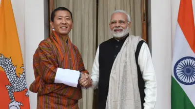 Indian Prime Minister Narendra Modi (R) shakes hands with Bhutan's Prime Minister Lotay Tshering prior to a meeting in New Delhi on December 28, 2018. (