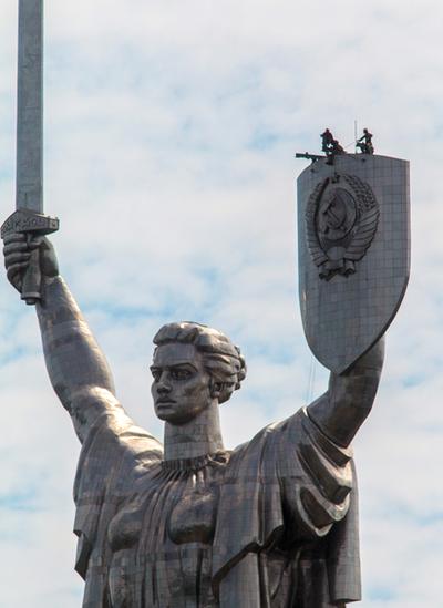 Workers prepare to dismantle the state emblem of the Soviet Union from the shield of the Motherland Monument in Kyiv as it will be replaced by the Trident - Ukraine's coat of arms. Photo: July 2023