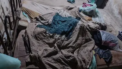An unmade bed inside the house where the three people were kept captive for 17 years