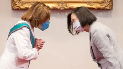Nancy Pelosi and Taiwan's President Tsai Ing-wen bowing to each other
