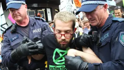 A man is arrested by police during an Extinction Rebellion protest in Sydney