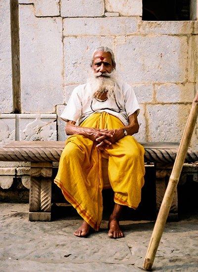 A man sitting outside a temple near the Amber Fort, Jaipur, in Rajasthan.