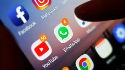 A thumb on a phone with social media icons