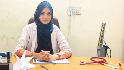 Saleema Rehman sitting behind a desk in her clinic