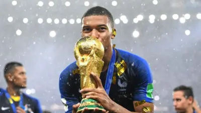 Mbappe kissing the World Cup trophy in 2018