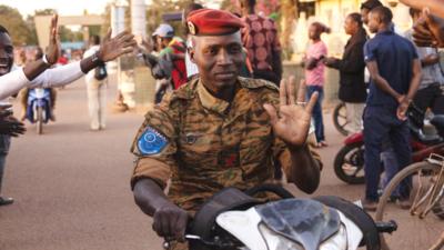 A soldier drives on a motorcycle as people gather to celebrate and support the Burkina Faso military in Ouagadougou - 24 January 2022