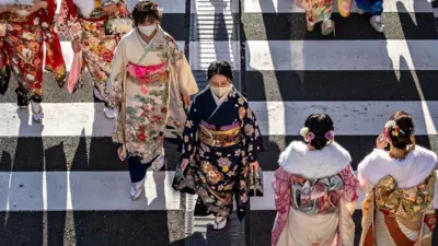 Young women wear kimonos to mark "Coming of Age Day" to honour people who turn 20 this year to signify adulthood, in Yokohama, Kanagawa prefecture on January 9, 2023.