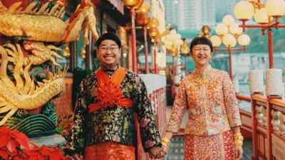 A Hong Kong couple in traditional wedding costume standing on the deck of Jumbo restaurant