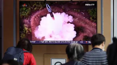 Satellite launch on TV in Seoul