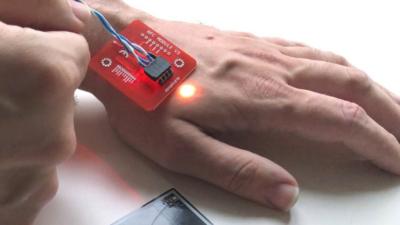 Patrick Paumen's payment chip implant lights up
