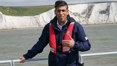 A picture of Rishi Sunak on a boat during a visit to Dover