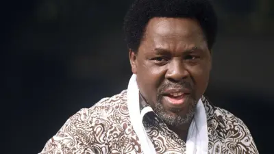 TB Joshua speaks during a New Year's memorial service for the South African relatives of those killed in a building collapse at his Lagos megachurch on December 31, 2014