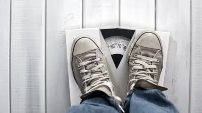 Feet wey dey on weighing scale