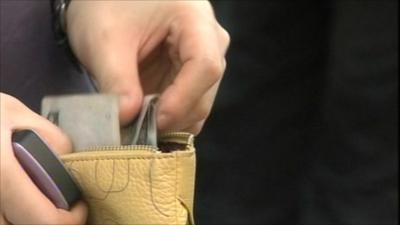 Money being taken out of wallet