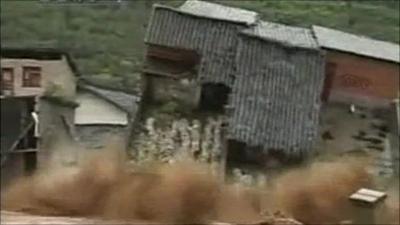 House toppled by flood waters