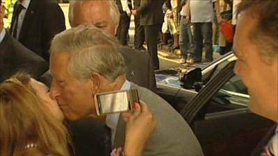 Prince Charles kissing lady on cheek