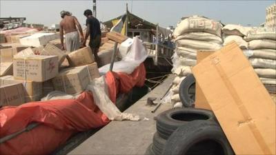 Men loading cargo on to boat