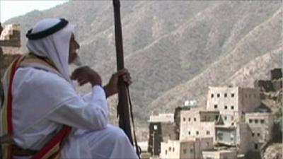 Man with gun looking over city