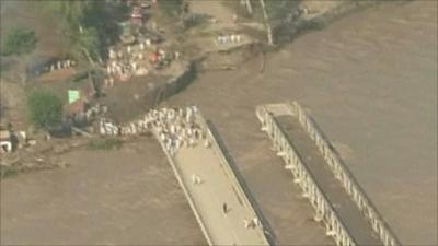 The rain damages a bridge