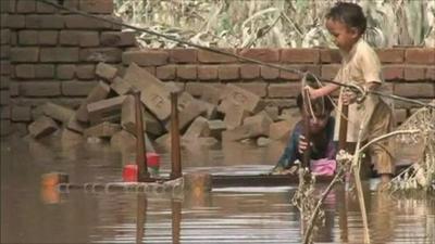 Children playing amid the flood damage